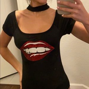 Women’s black top with strap around neck and lips